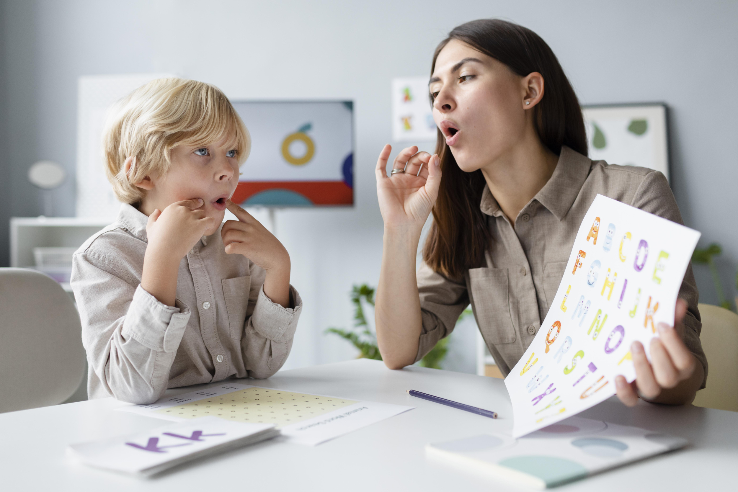 1 woman-doing-speech-therapy-with-little-blonde-boy.jpg