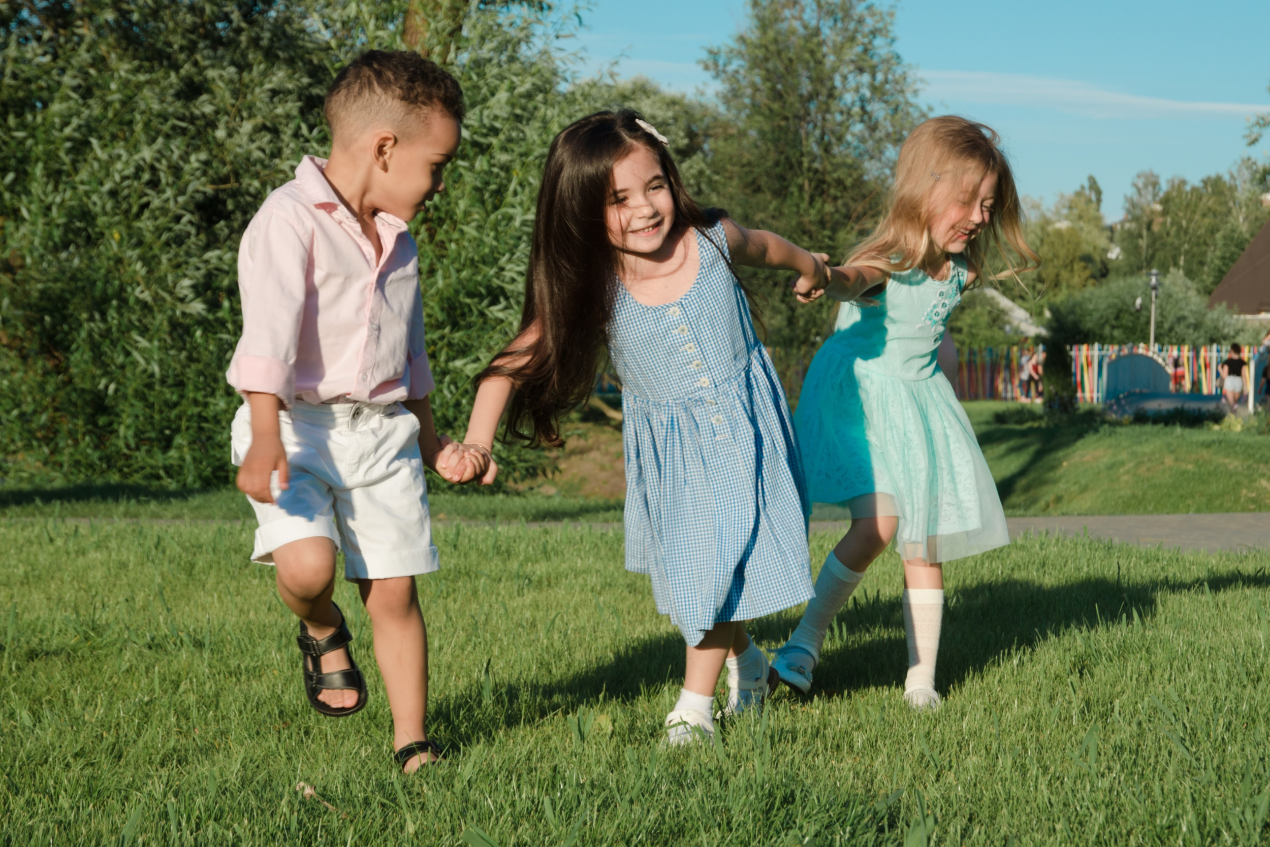 little-kids-playing-around-lawn-two-girls-boy.jpg