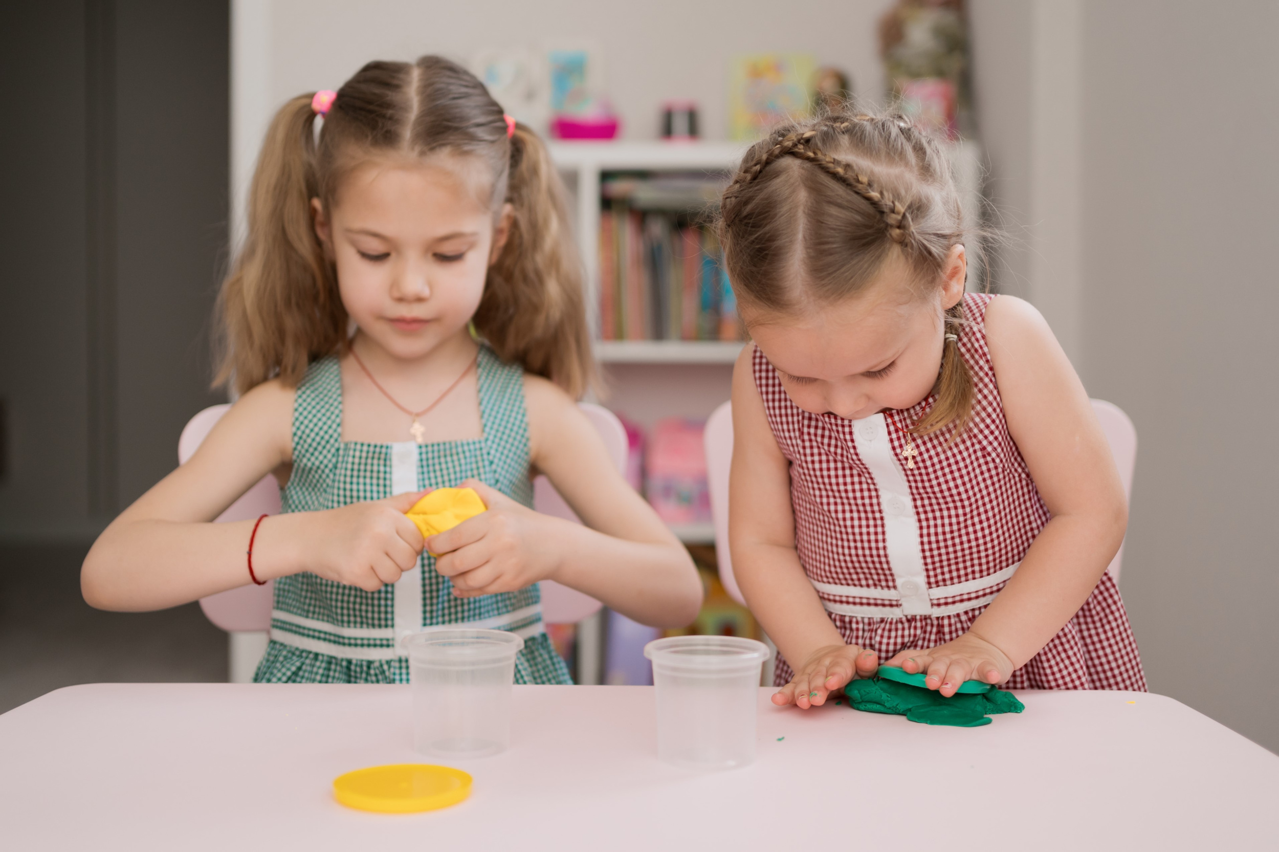 1 cute-little-girls-moulding-from-plasticine-pink-table.jpg