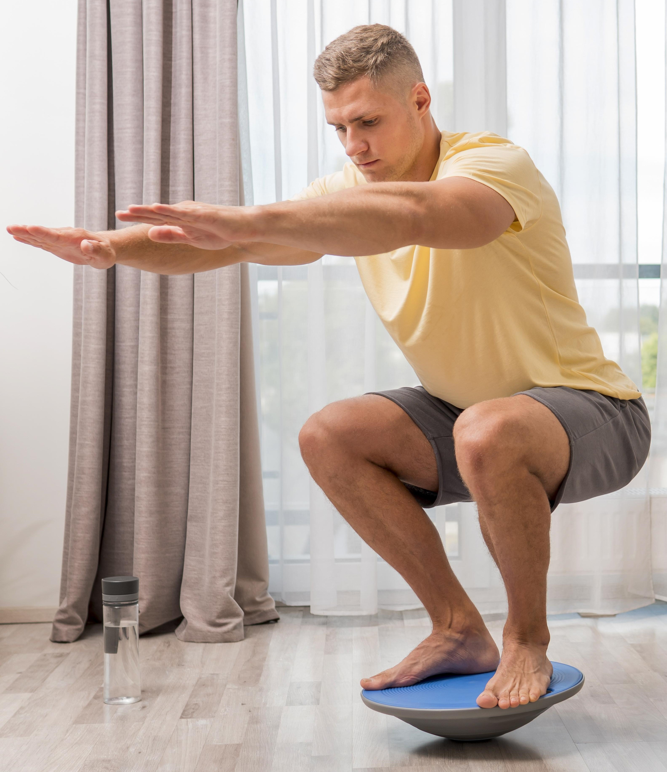 side-view-man-training-home-using-bosu-ball.jpg