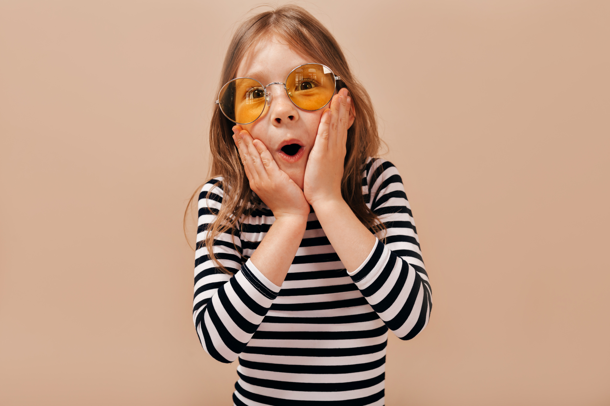 2 charming-pretty-little-6-years-old-girl-with-light-hair-wearing-stripped-shirt-posing-with-open-mouth-holds-hands-check.jpg