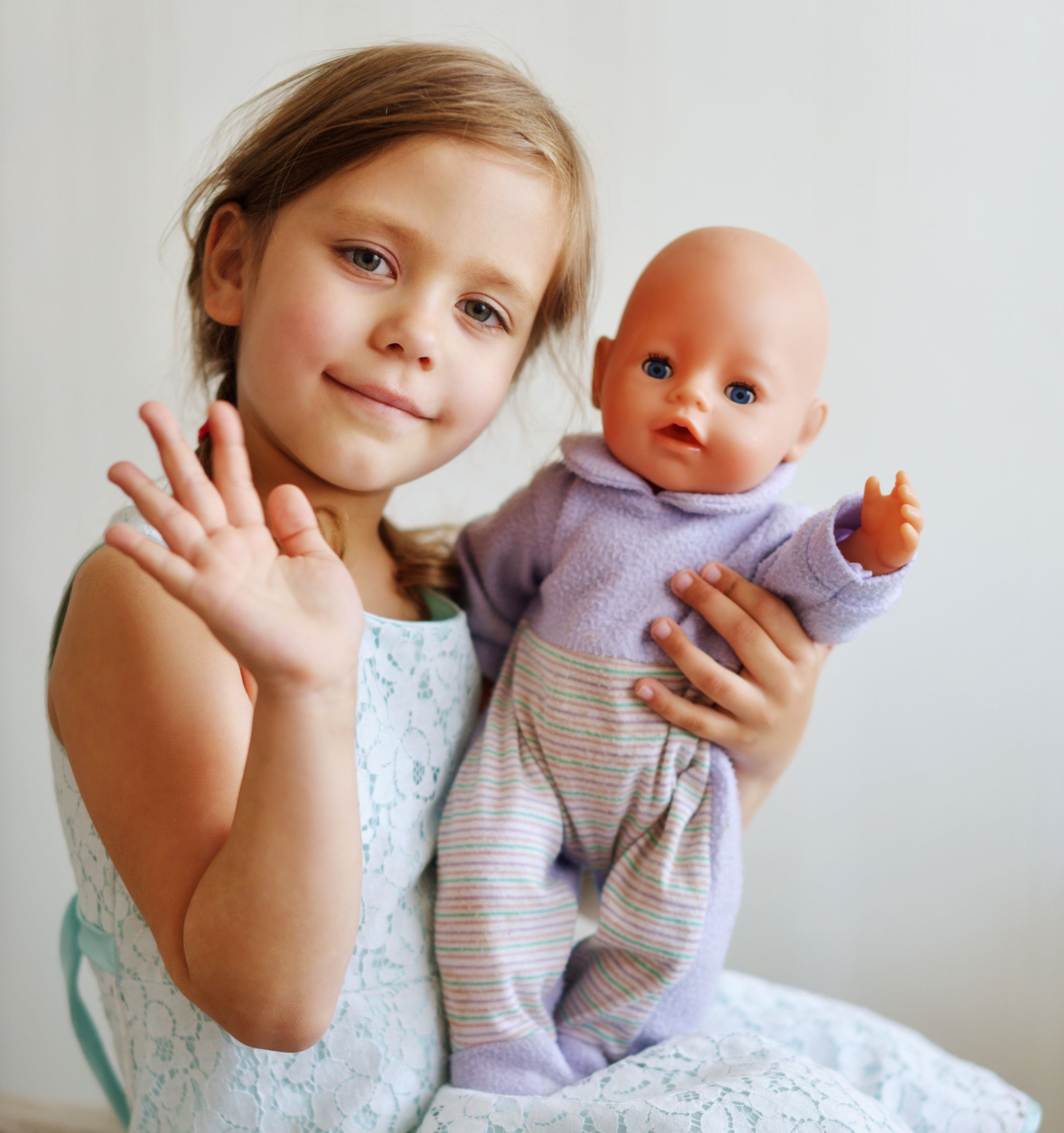 girl-playing-with-her-doll-home.jpg