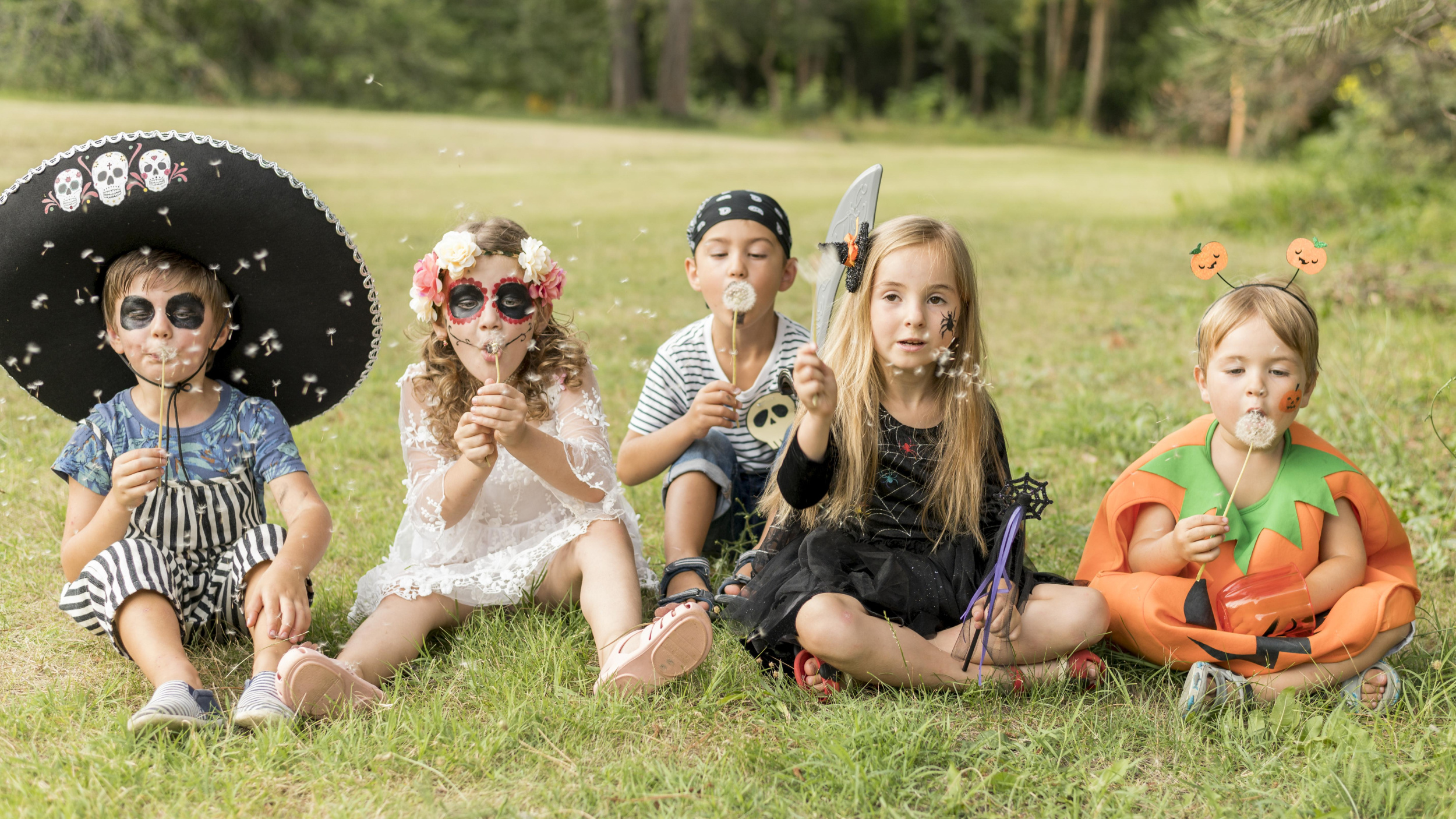 1 kids-costumated-halloween-sitting-grass.jpg