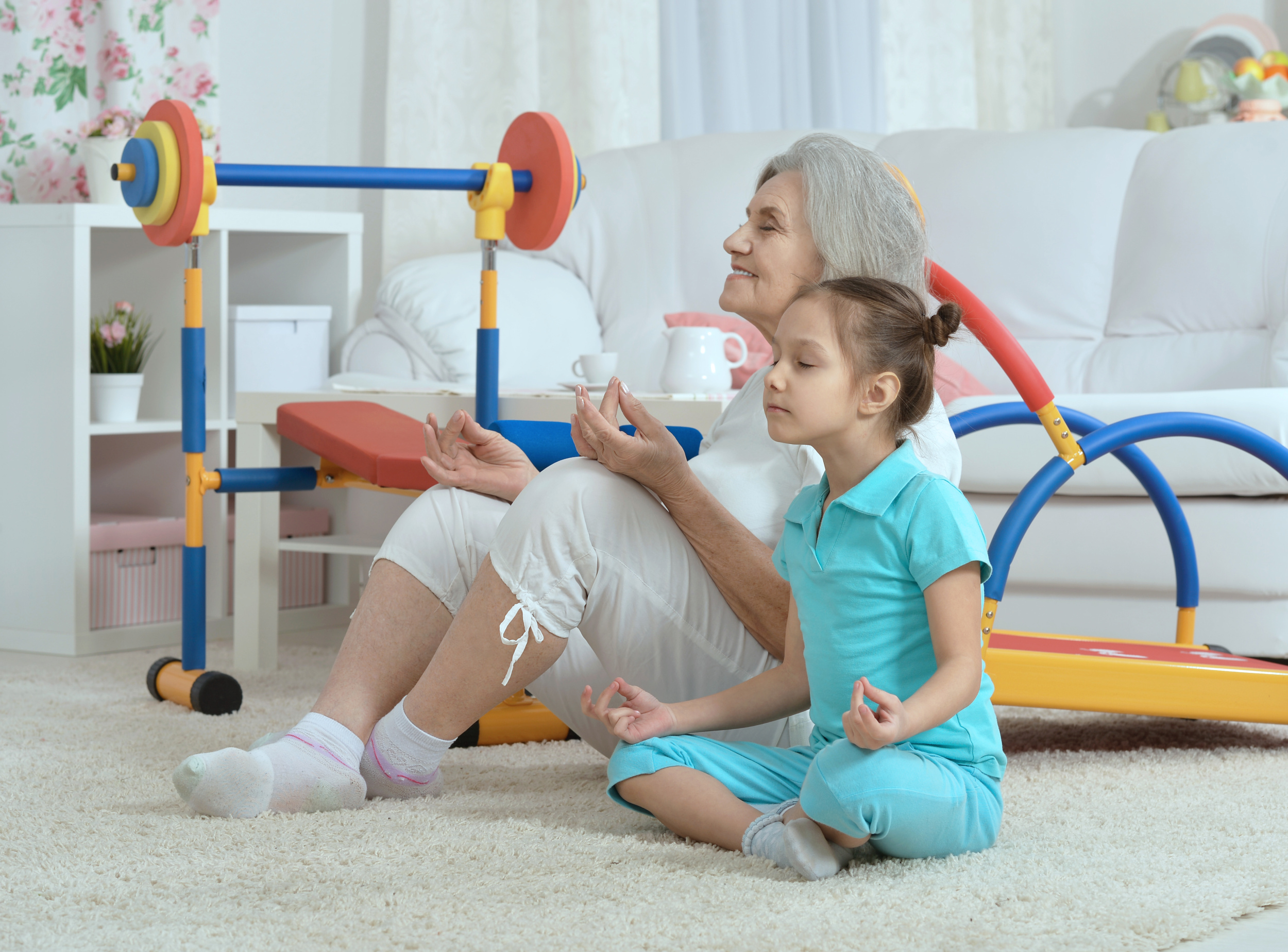 senior-woman-little-granddaughter-doing-exercise-home.jpg