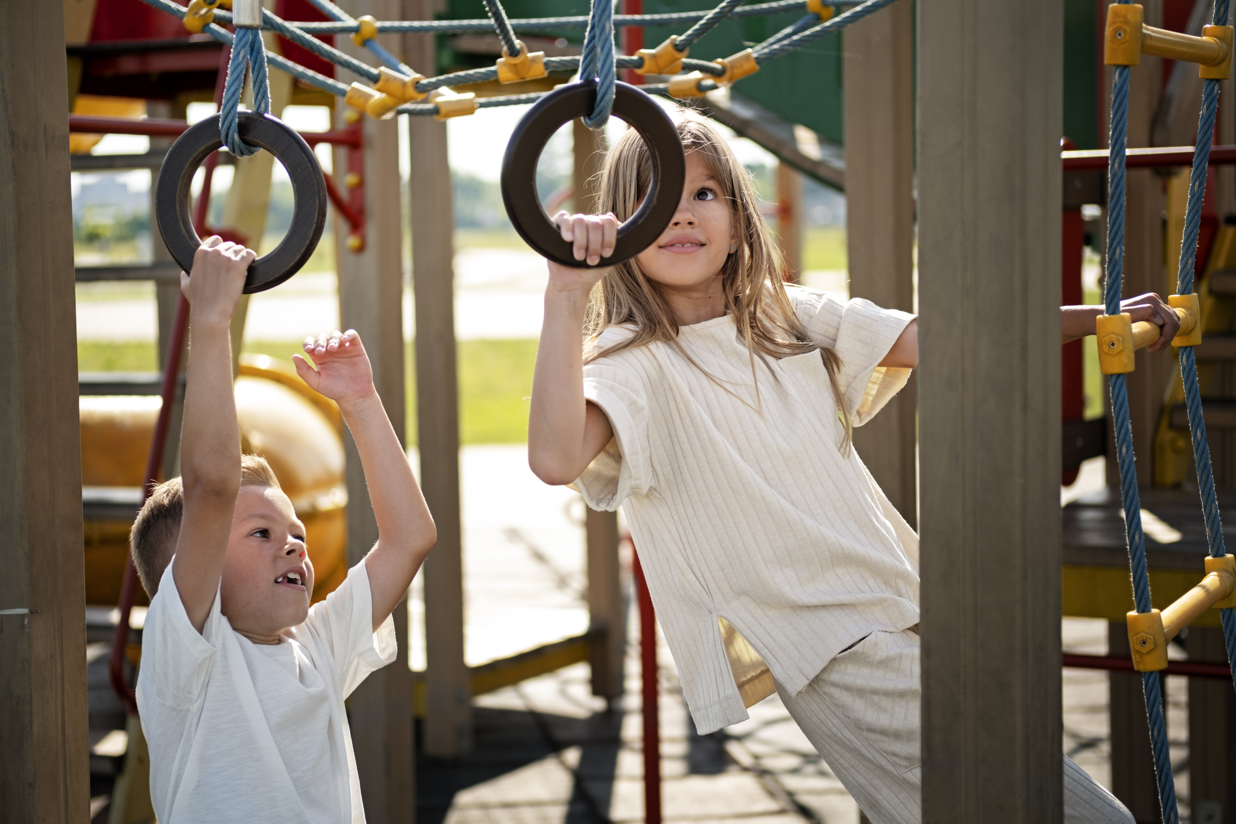 3 brother-sister-having-fun-outdoors-playground.jpg