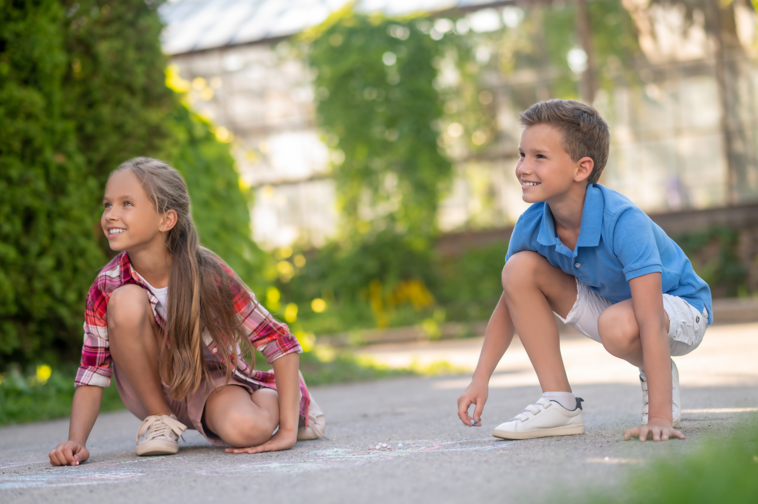 3 joyous-children-drawing-with-colored-chalks-ground.jpg