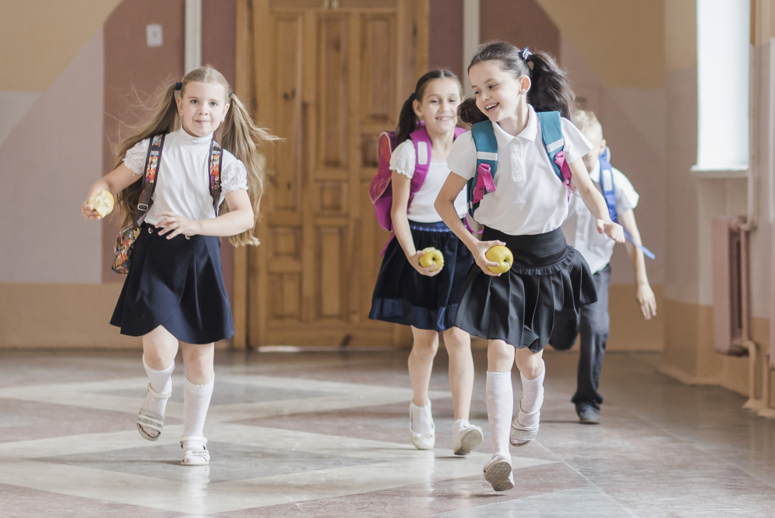 3 cheerful-kids-running-school-corridor.jpg